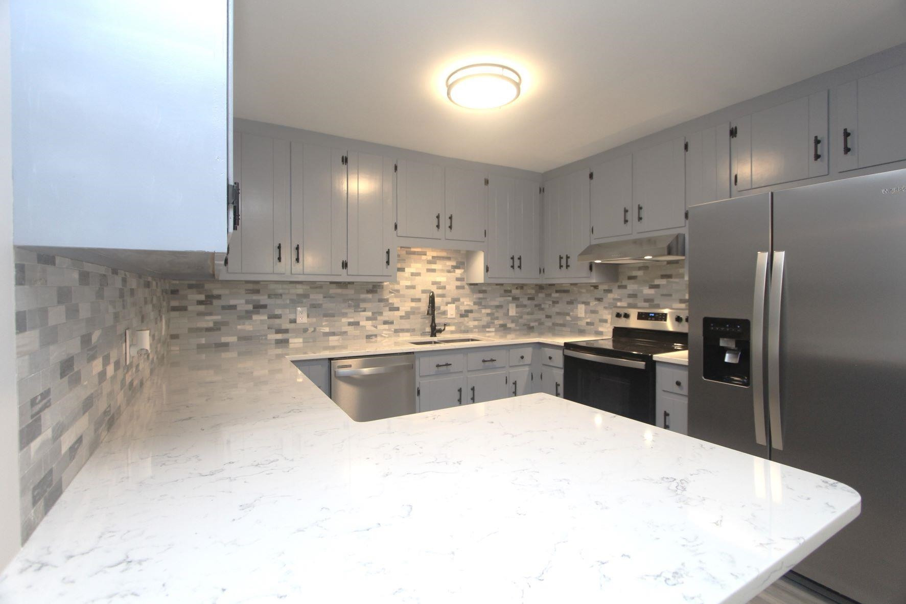 4161 Range Road Stem, NC 27581 - Photo 17 of 43 a kitchen with granite countertop a refrigerator sink and cabinets
