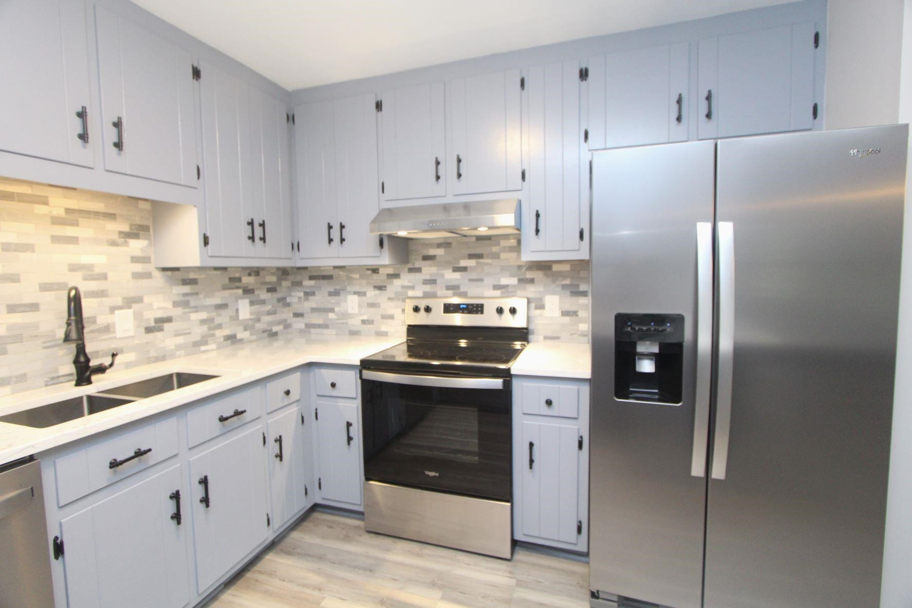 4161 Range Road Stem, NC 27581 - Photo 18 of 43 a kitchen with stainless steel appliances granite countertop a refrigerator stove and white cabinets