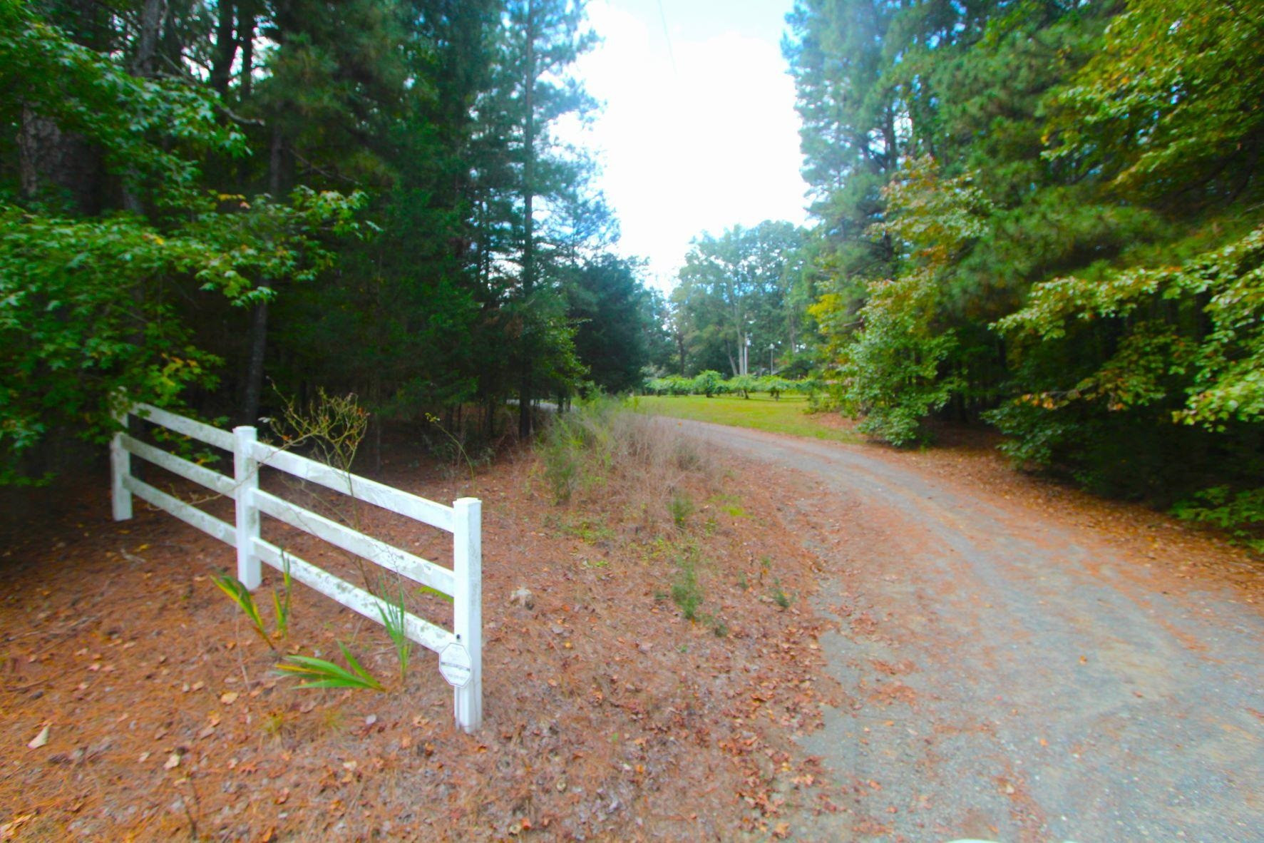 4161 Range Road Stem, NC 27581 - Photo 2 of 43 a view of a backyard with wooden fence and trees