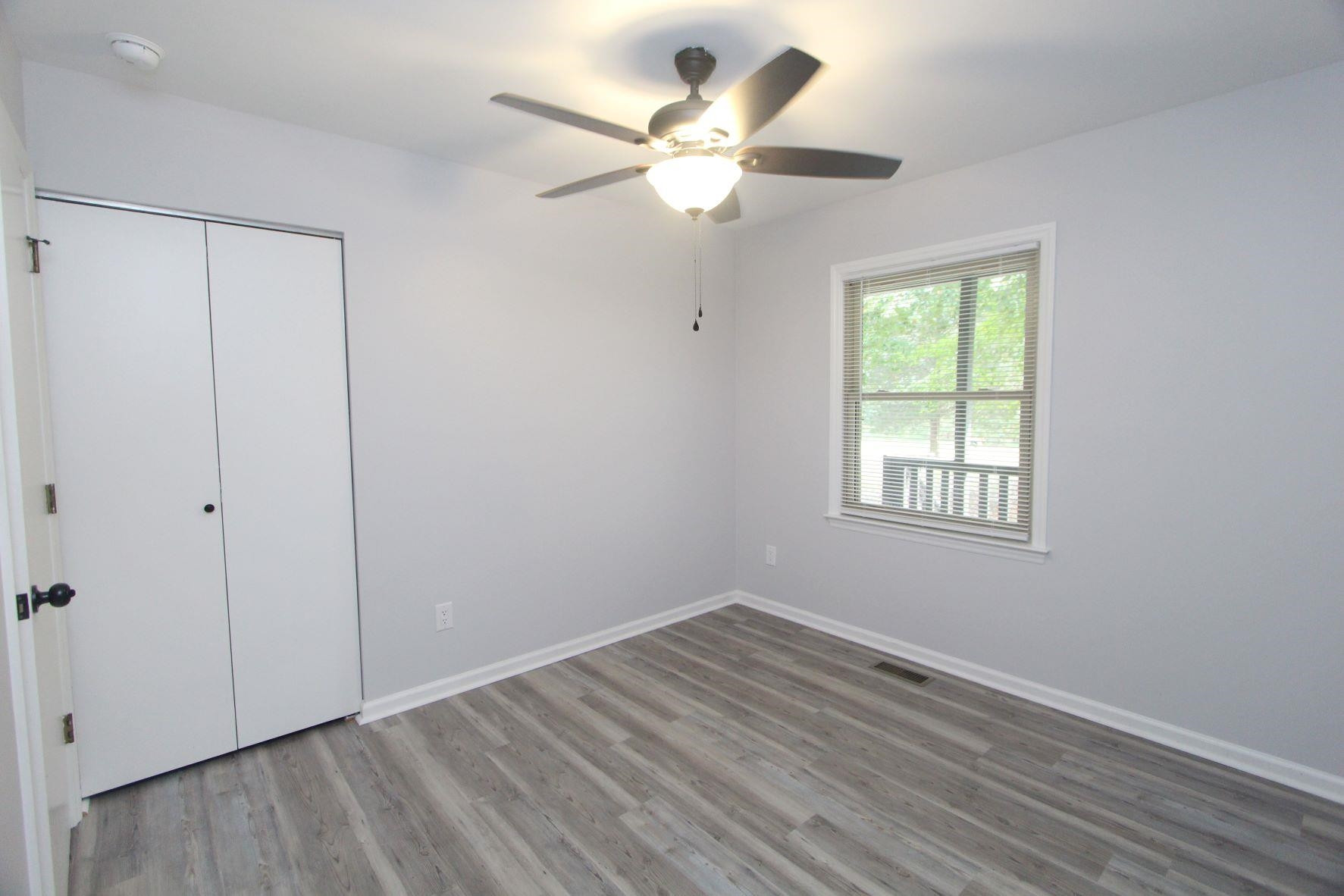 4161 Range Road Stem, NC 27581 - Photo 21 of 43 a view of an empty room with wooden floor and a window