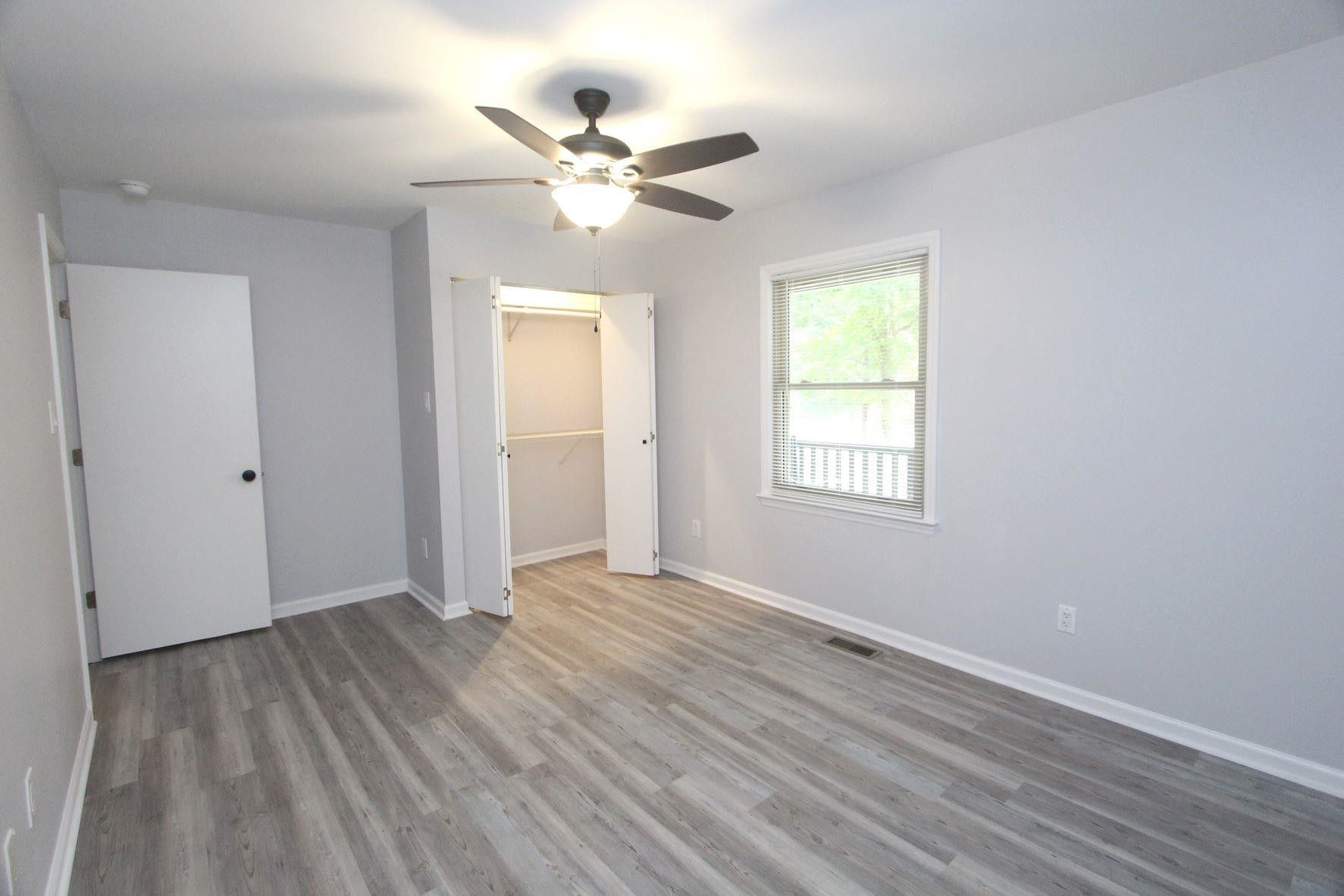 4161 Range Road Stem, NC 27581 - Photo 24 of 43 a view of an empty room with wooden floor and a window