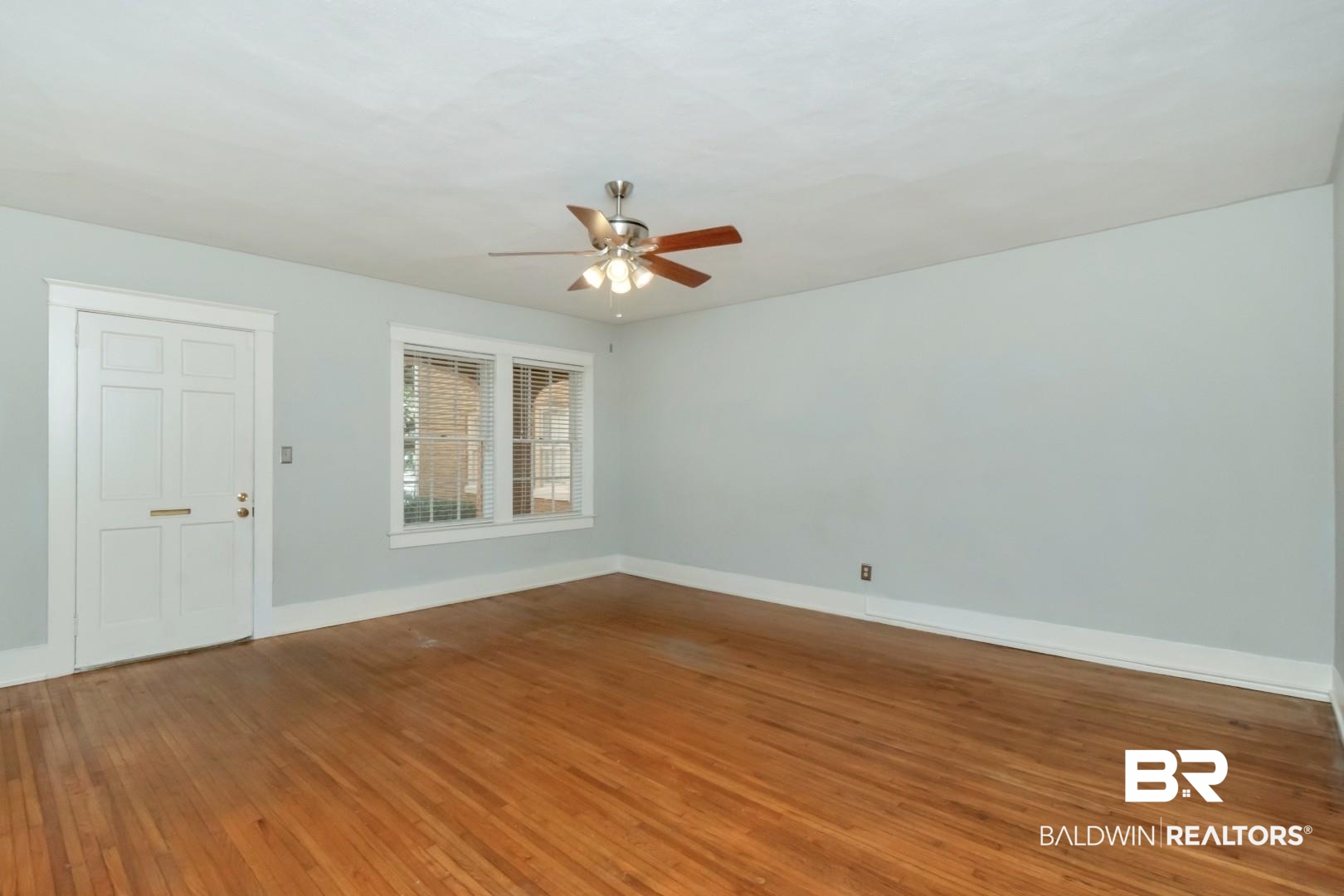 1602 Government Street, Unit 1A Mobile, AL 36604 - Photo 7 of 24 Empty room with wood-type flooring and a ceiling fan