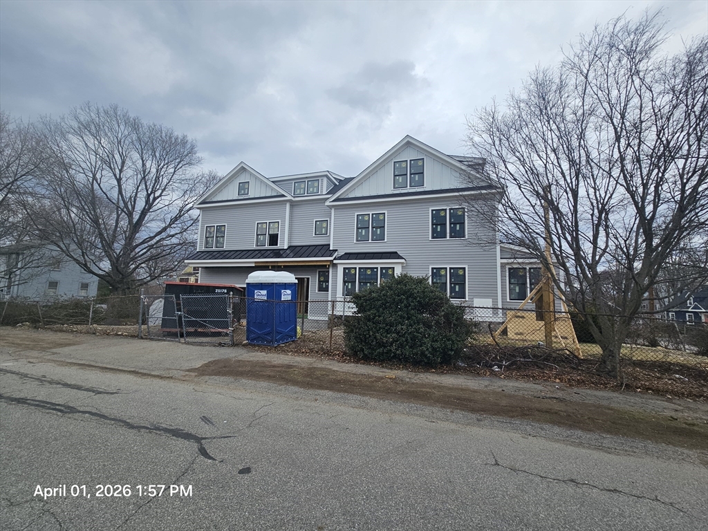 11 Greenough Street Needham, MA 02494 - Photo 2 of 4 a front view of a house with a yard and garage