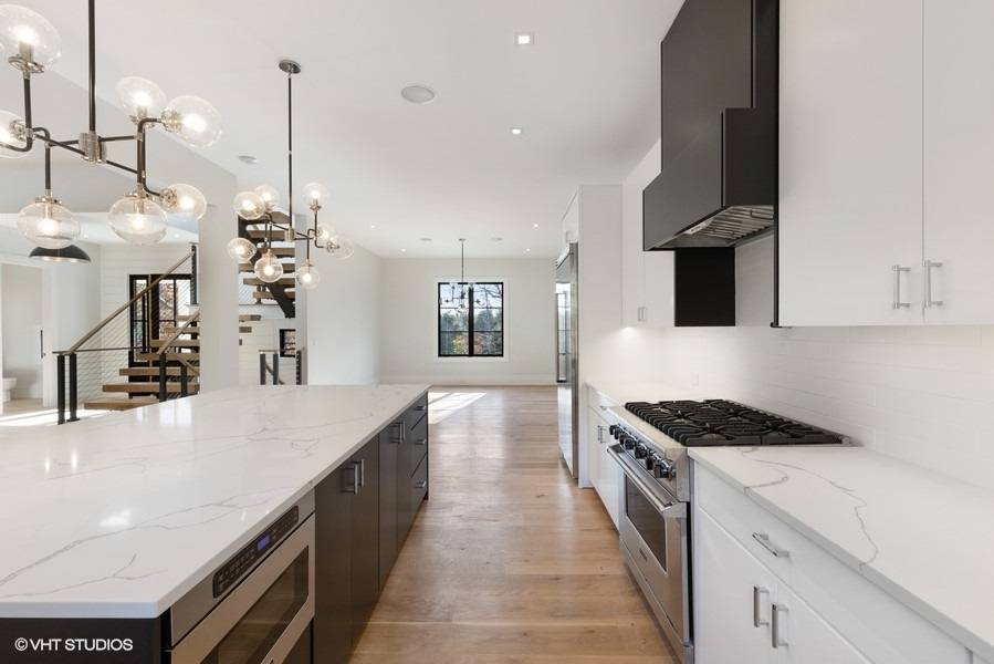 8 Crows Nest Lane East Hampton, NY 11937 - Photo 5 of 15 a kitchen with granite countertop a stove and a sink