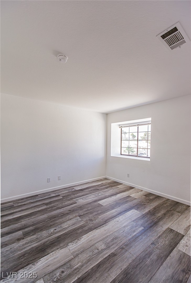306 Lander Drive Henderson, NV 89074 - Photo 16 of 30 Unfurnished room featuring baseboards and wood finished floors