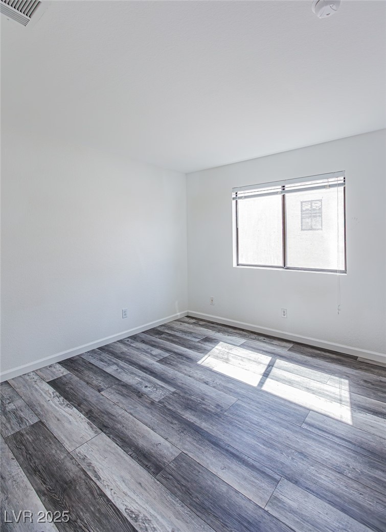 306 Lander Drive Henderson, NV 89074 - Photo 18 of 30 Empty room featuring wood finished floors and baseboards