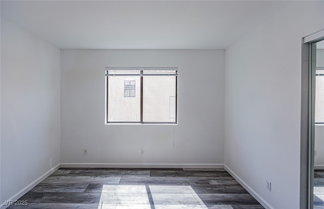 306 Lander Drive Henderson, NV 89074 - Photo 19 of 30 Unfurnished room featuring dark wood-style flooring and baseboards