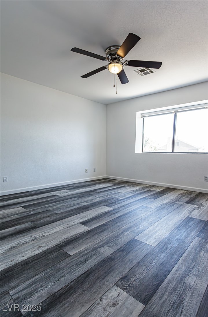 306 Lander Drive Henderson, NV 89074 - Photo 22 of 30 Empty room with wood finished floors and ceiling fan