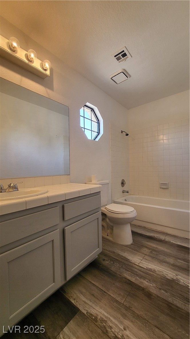 306 Lander Drive Henderson, NV 89074 - Photo 27 of 30 Bathroom with vanity, shower / tub combination, dark wood-style floors, and a textured ceiling