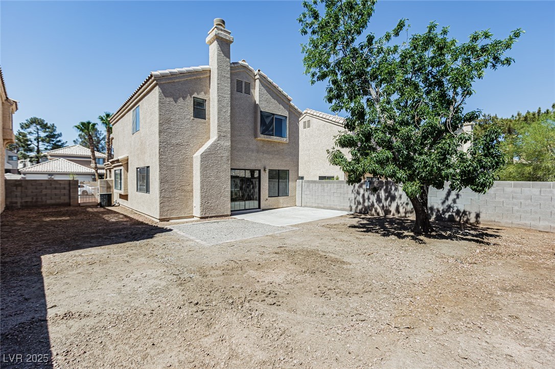 306 Lander Drive Henderson, NV 89074 - Photo 30 of 30 Back of property with stucco siding, a patio, a fenced backyard, and a chimney