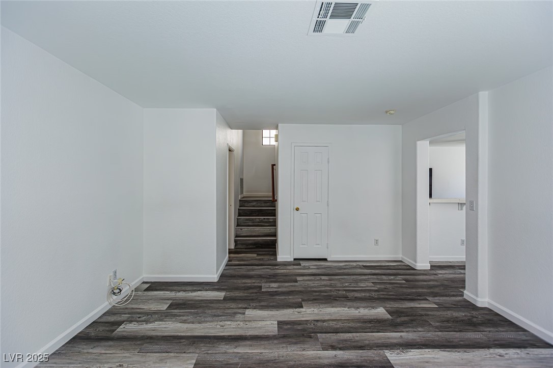 306 Lander Drive Henderson, NV 89074 - Photo 3 of 30 Unfurnished room with stairway and dark wood-type flooring