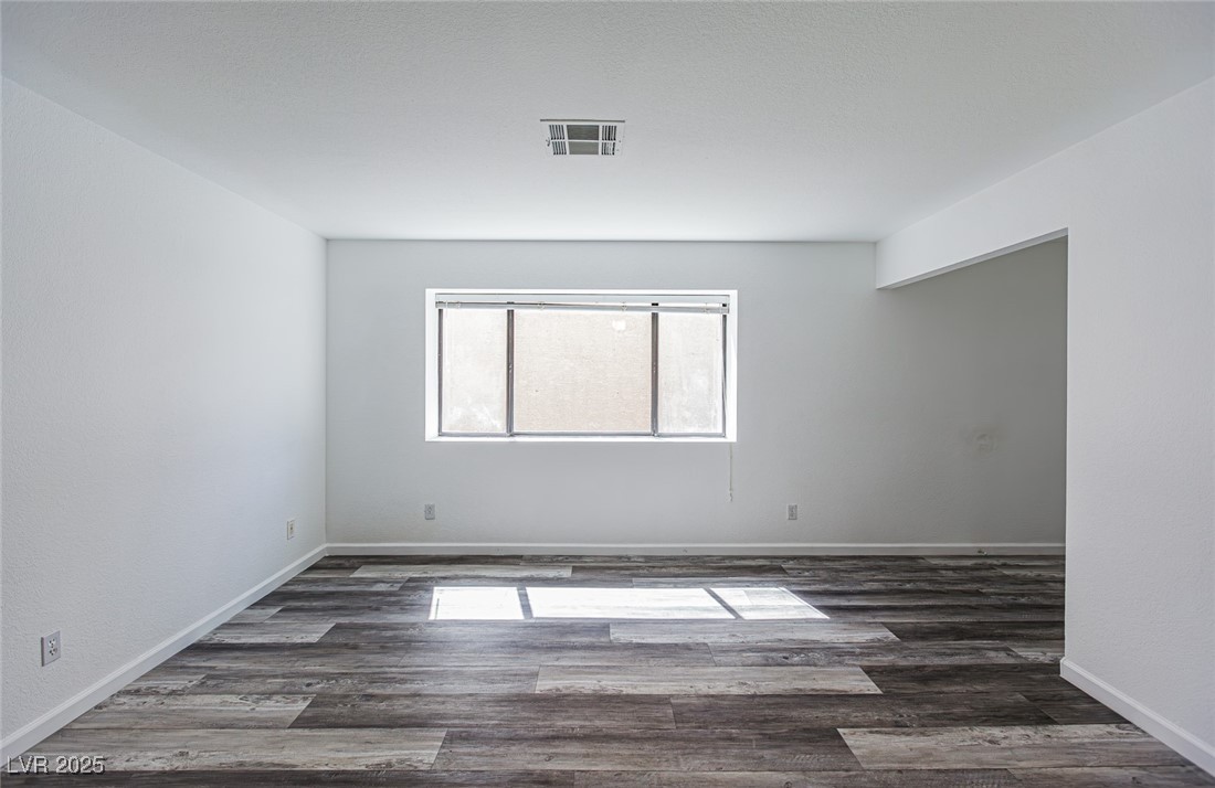 306 Lander Drive Henderson, NV 89074 - Photo 4 of 30 Empty room with dark wood-style flooring
