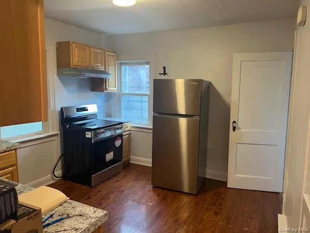 a kitchen with a refrigerator and a sink