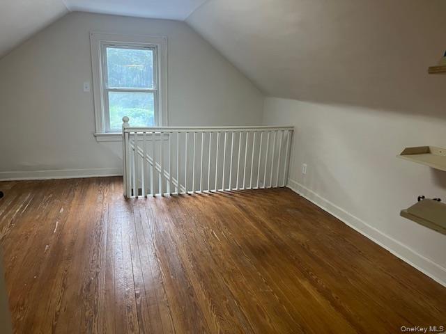 495 Community Drive Manhasset, NY 11030 - Photo 8 of 13 an empty room with wooden floor and windows