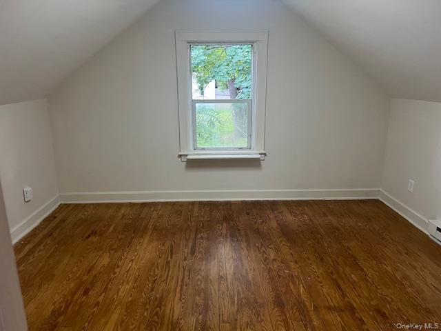 495 Community Drive Manhasset, NY 11030 - Photo 9 of 13 a view of an empty room with wooden floor and a window