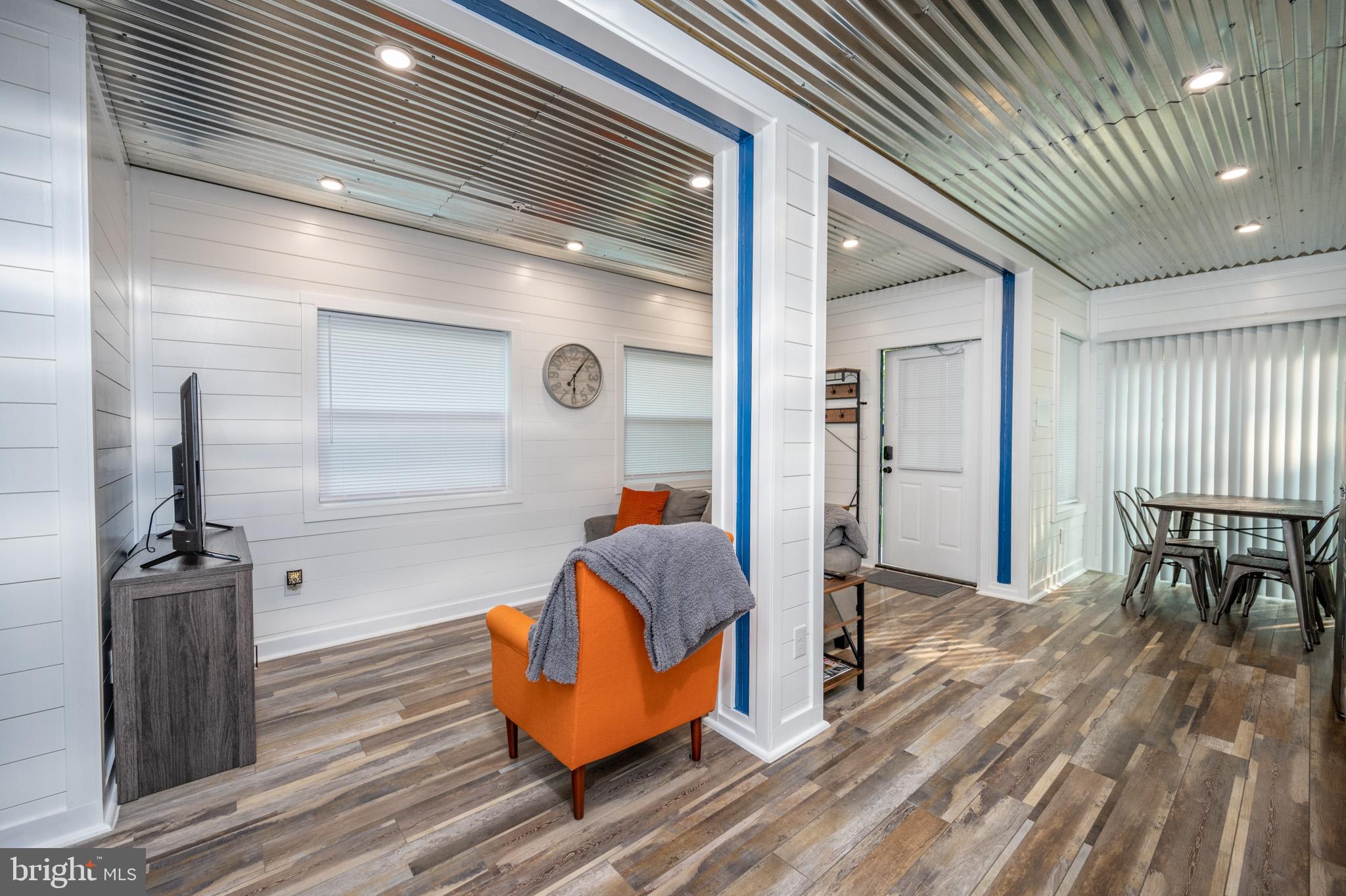 2195 Glendale Road Swanton, MD 21561 - Photo 11 of 35 a view of living room kitchen with furniture and wooden floor