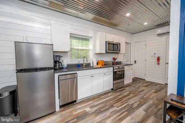 a kitchen with a refrigerator a sink and a stove