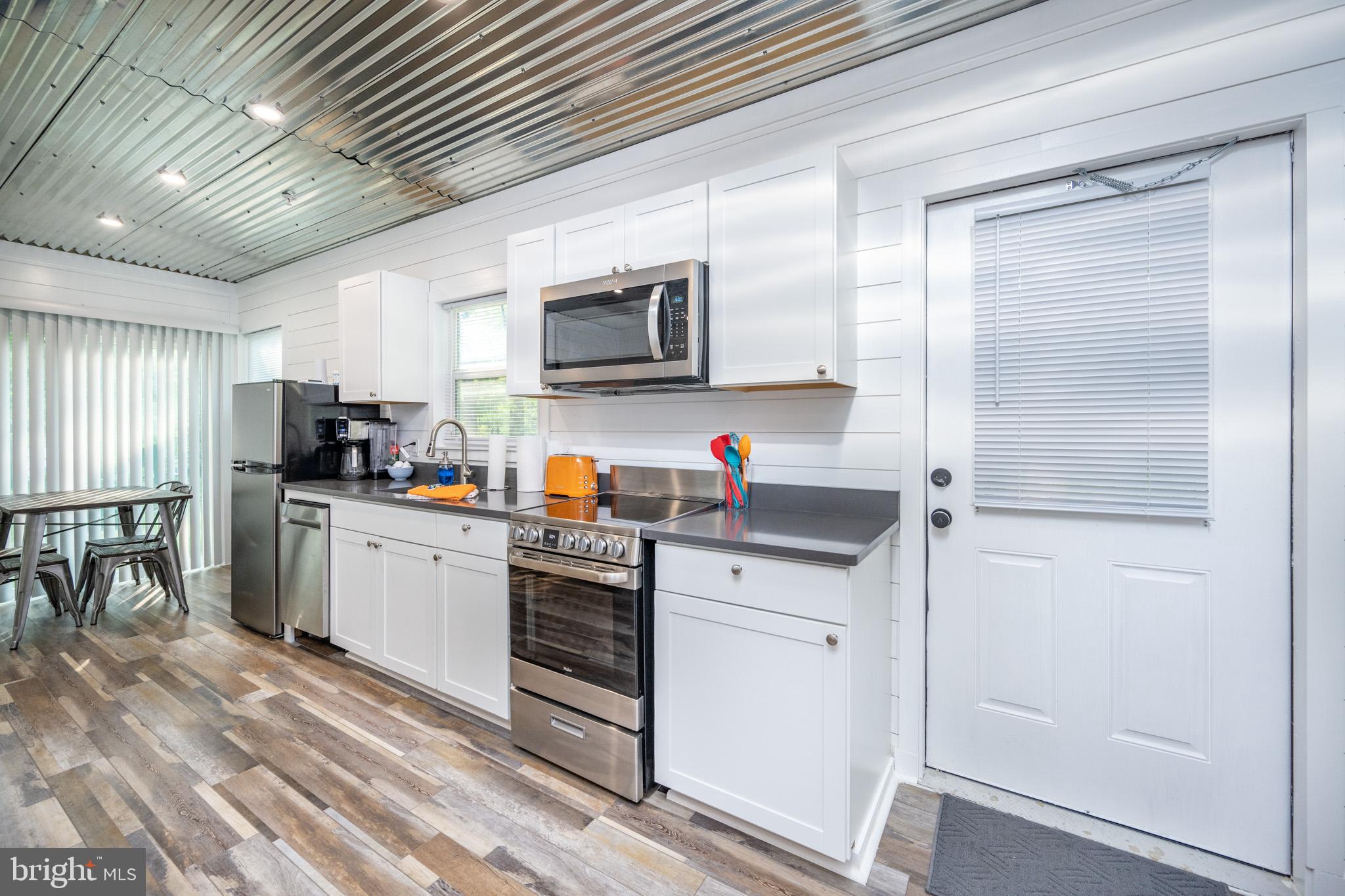 2195 Glendale Road Swanton, MD 21561 - Photo 14 of 35 a kitchen with stainless steel appliances a refrigerator sink and microwave
