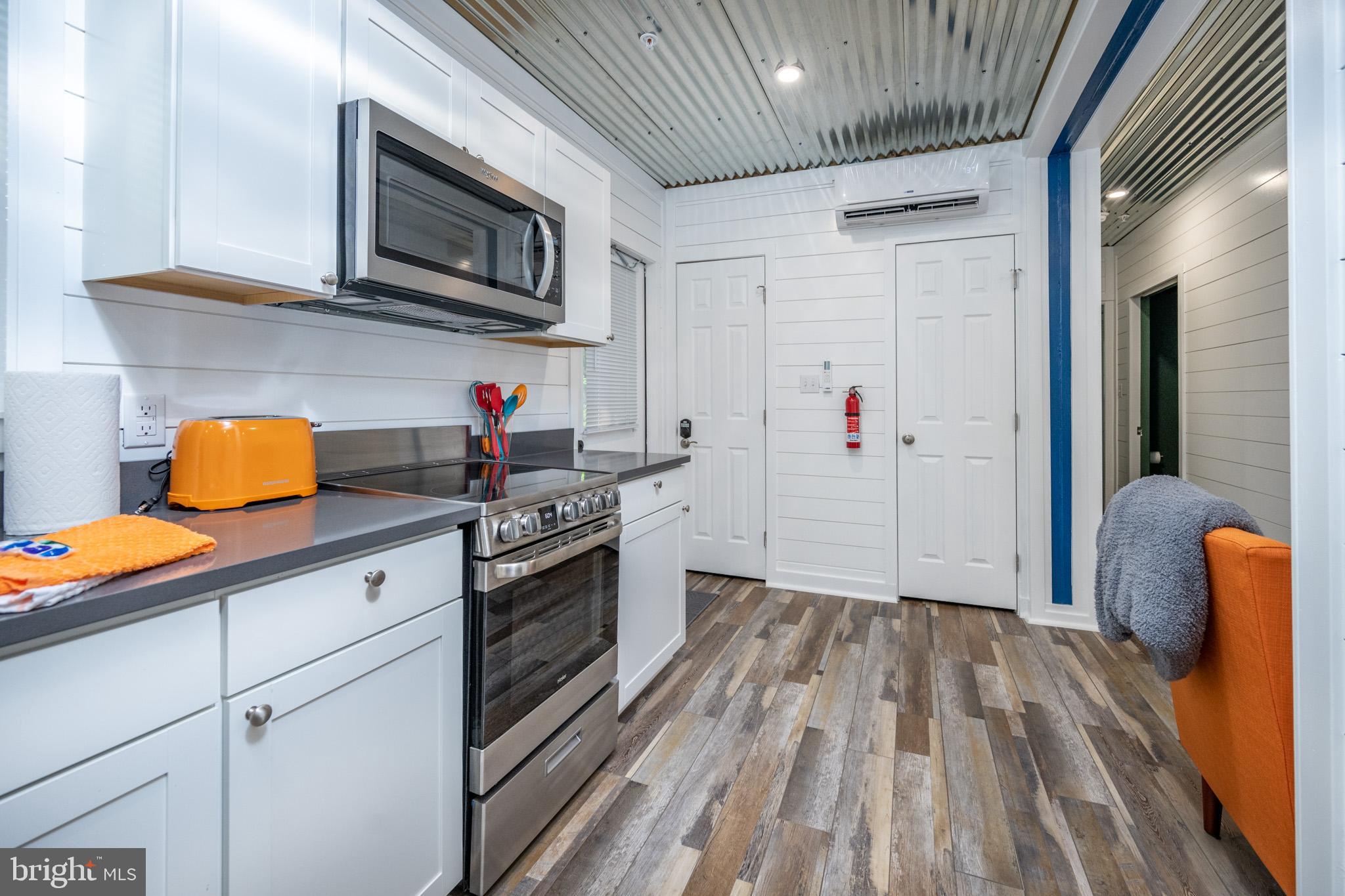2195 Glendale Road Swanton, MD 21561 - Photo 16 of 35 a kitchen with stainless steel appliances granite countertop a sink stove and refrigerator