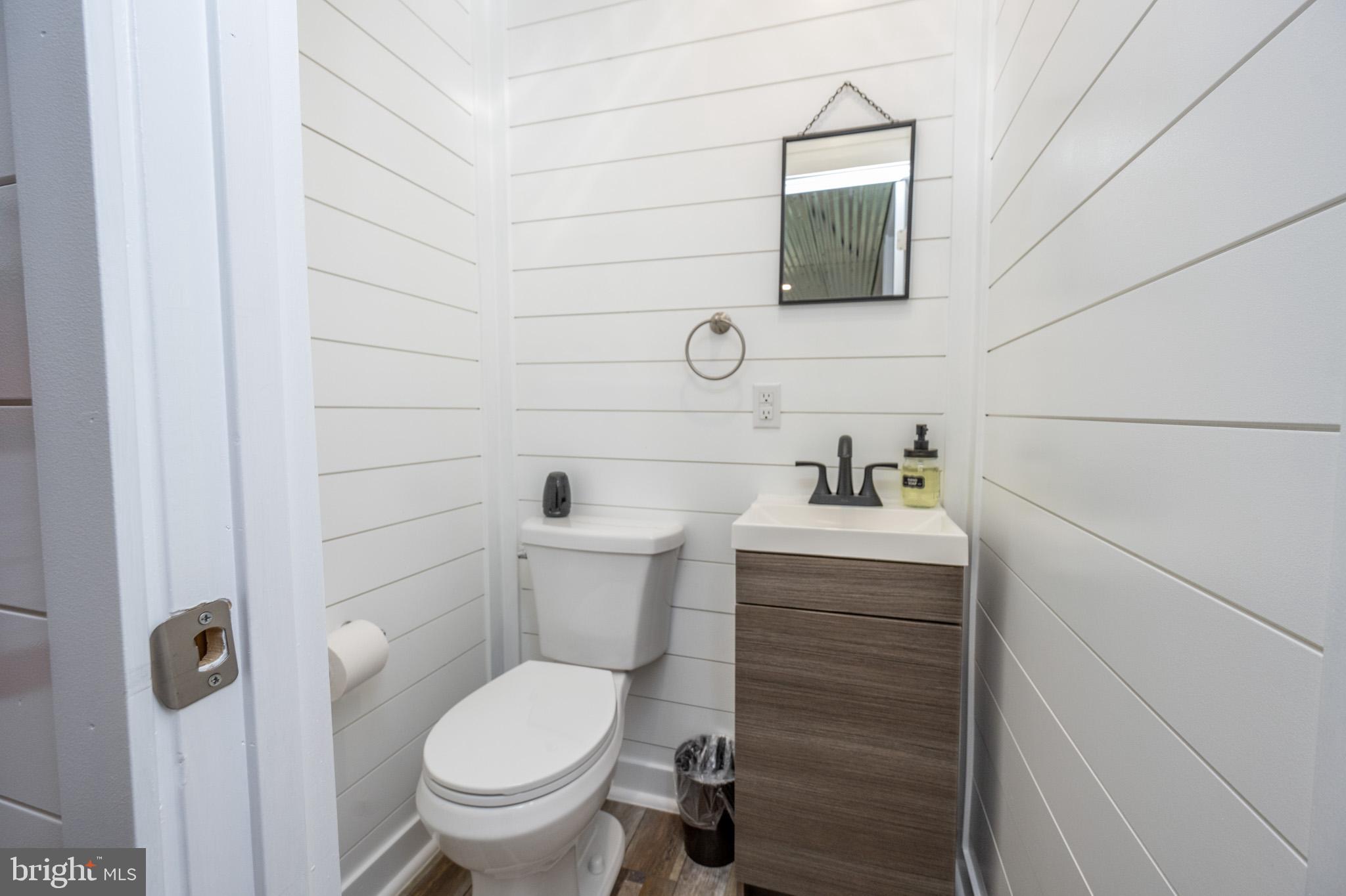 2195 Glendale Road Swanton, MD 21561 - Photo 20 of 35 a bathroom with a toilet sink and mirror