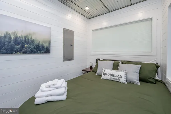 a bedroom with a bed and a couch
