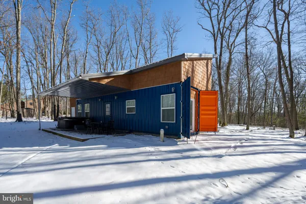 a front view of house with a garden