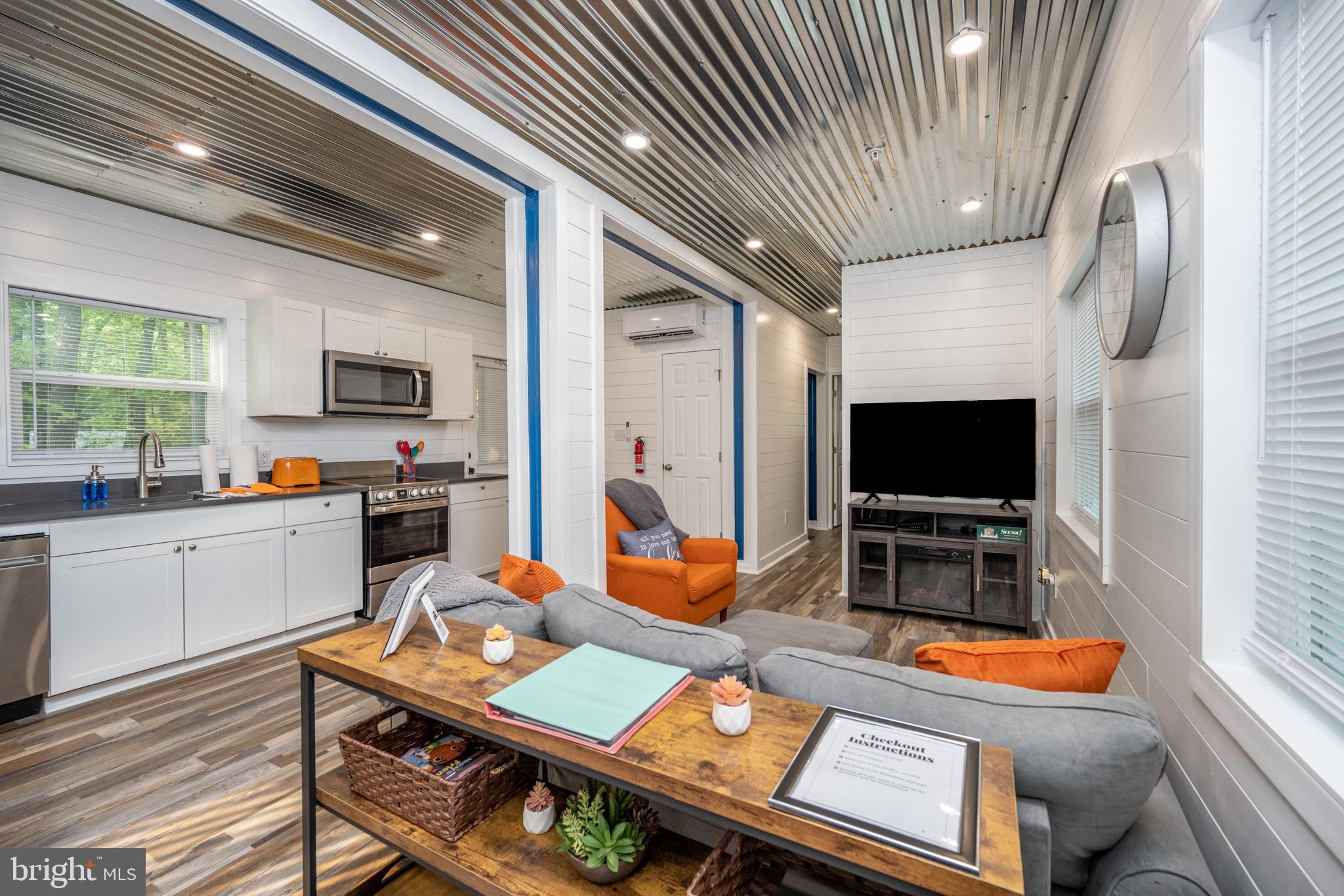 2195 Glendale Road Swanton, MD 21561 - Photo 7 of 35 a living room with furniture and a flat screen tv
