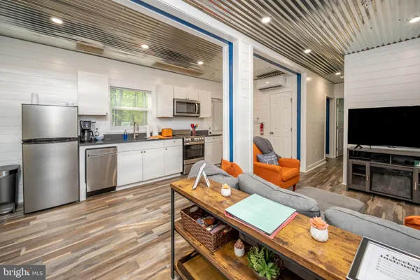 a kitchen with stainless steel appliances granite countertop a stove refrigerator sink and cabinets
