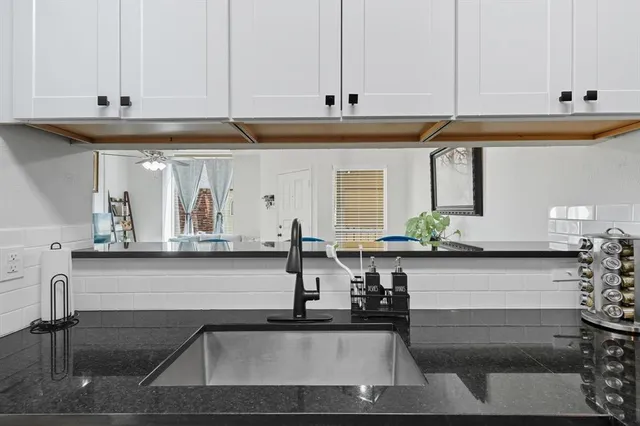 a kitchen with a sink and cabinets