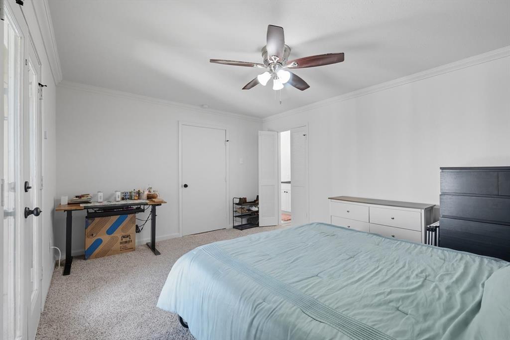 4430 Point Boulevard, Unit 203 Garland, TX 75043 - Photo 26 of 40 a bedroom with a bed and a chandelier