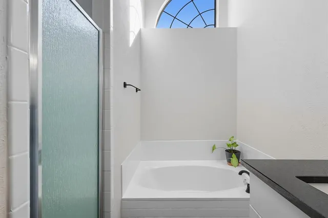 a spacious bathroom with a double vanity sink and a mirror