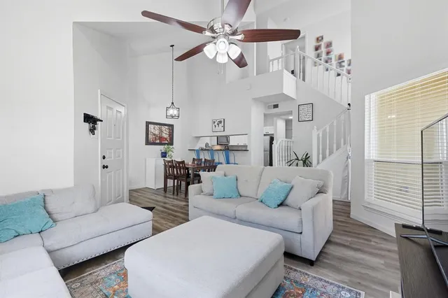 a living room with furniture and a chandelier