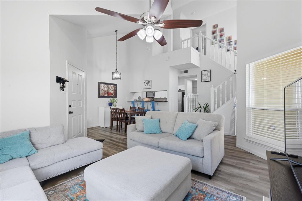 4430 Point Boulevard, Unit 203 Garland, TX 75043 - Photo 6 of 40 a living room with furniture and a chandelier