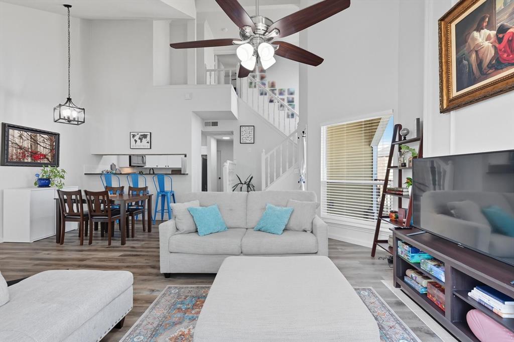 4430 Point Boulevard, Unit 203 Garland, TX 75043 - Photo 8 of 40 a living room with furniture and a chandelier