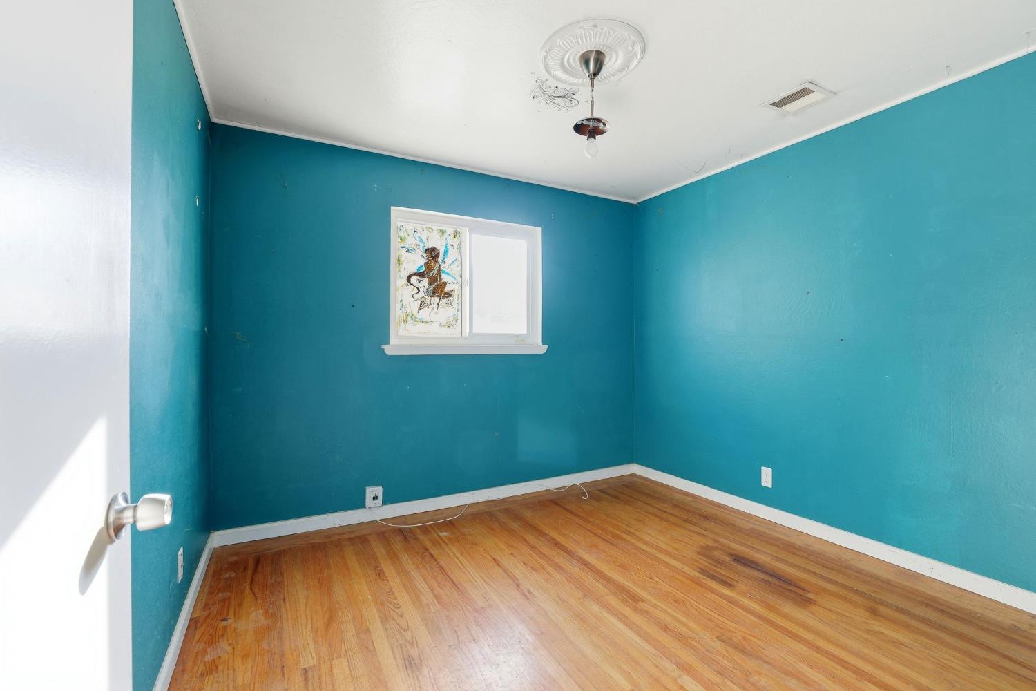 5674 Rio Verde Way North Highlands, CA 95660 - Photo 12 of 35 a view of a room with a wooden floor and a ceiling fan