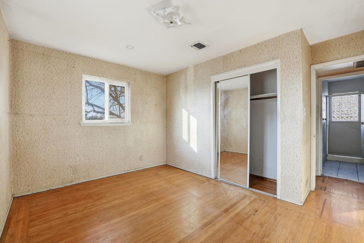 5674 Rio Verde Way North Highlands, CA 95660 - Photo 17 of 35 an empty room with wooden floor and windows