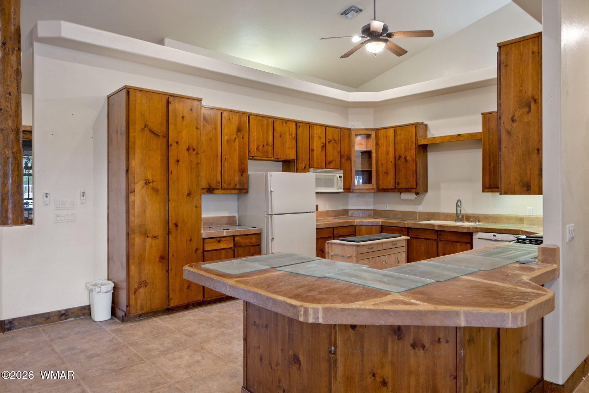 1955 Ricochet Ranch Road Overgaard, AZ 85933 - Photo 10 of 48 a kitchen with a stove a sink and a refrigerator