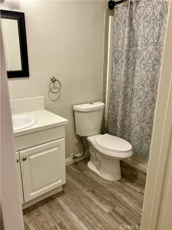 a bathroom with a toilet and a mirror
