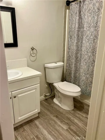 a bathroom with a toilet and a mirror