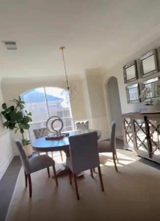 a view of a workspace room with furniture and window