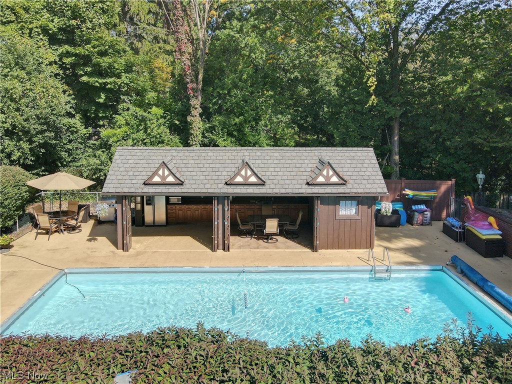 785 Merriman Road Akron, OH 44303 - Photo 28 of 34 View of swimming pool with an outdoor structure and a patio
