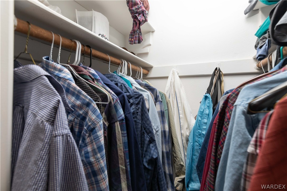 4214 Bluff Road Golden Valley, AZ 86413 - Photo 21 of 46 a view of walk in closet with clothes and shoes