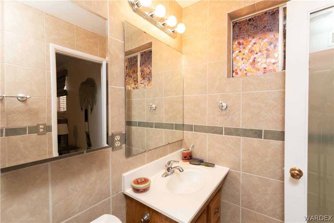 4214 Bluff Road Golden Valley, AZ 86413 - Photo 23 of 46 a bathroom with a sink a shower and a mirror