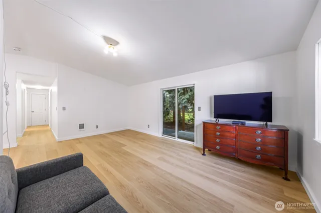 a bedroom with furniture and a flat screen tv