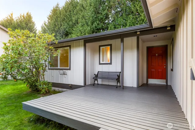 a view of backyard with a deck and furniture