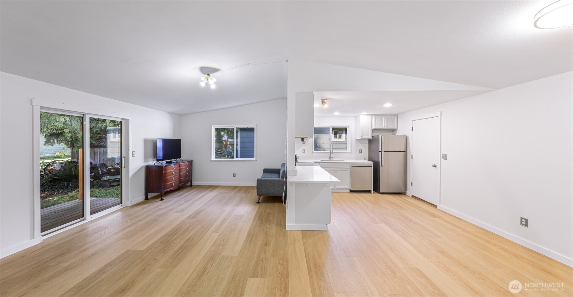 439 Fir Lane Sedro-Woolley, WA 98284 - Photo 5 of 29 a large living room with stainless steel appliances kitchen view and wooden floor