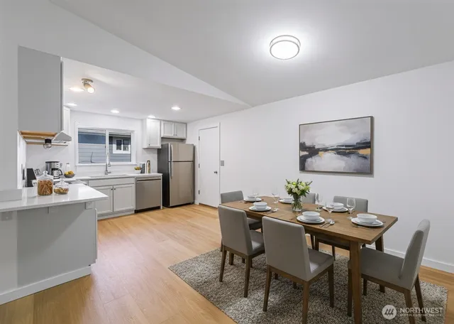 a view of a dining room with furniture and wooden floor