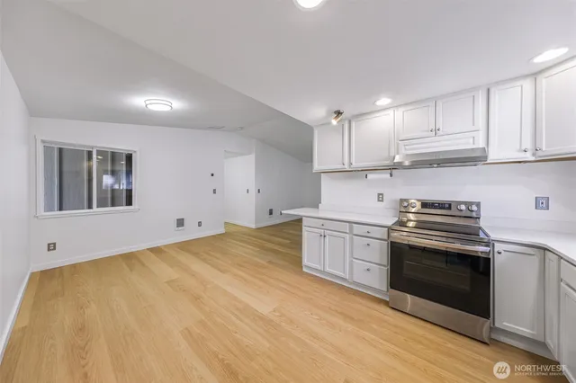 a kitchen with stainless steel appliances granite countertop a stove and a sink
