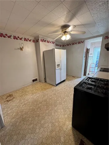 a kitchen with stainless steel appliances granite countertop a sink a stove and a refrigerator