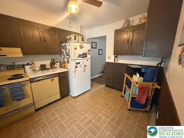 a kitchen with refrigerator and cabinets